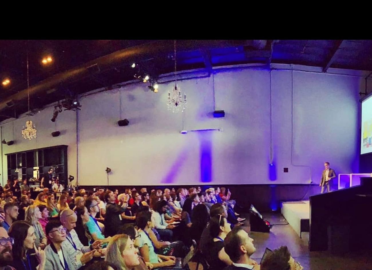 Chris Catania speaking onstage at CMX with the audience visible